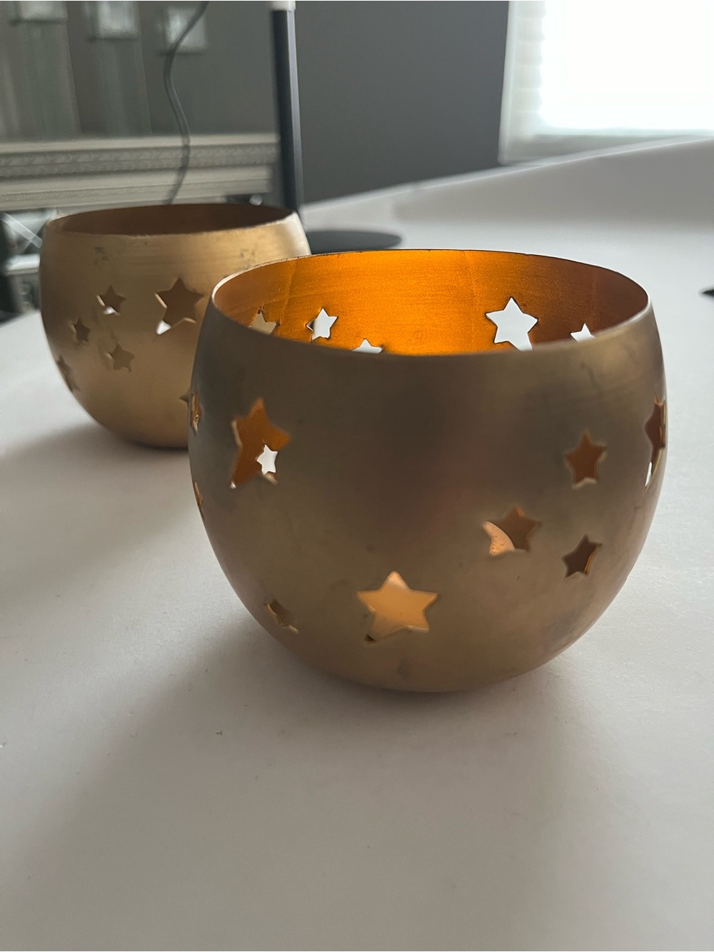 NWT two 4” brass colored candle holders decorated with stars.